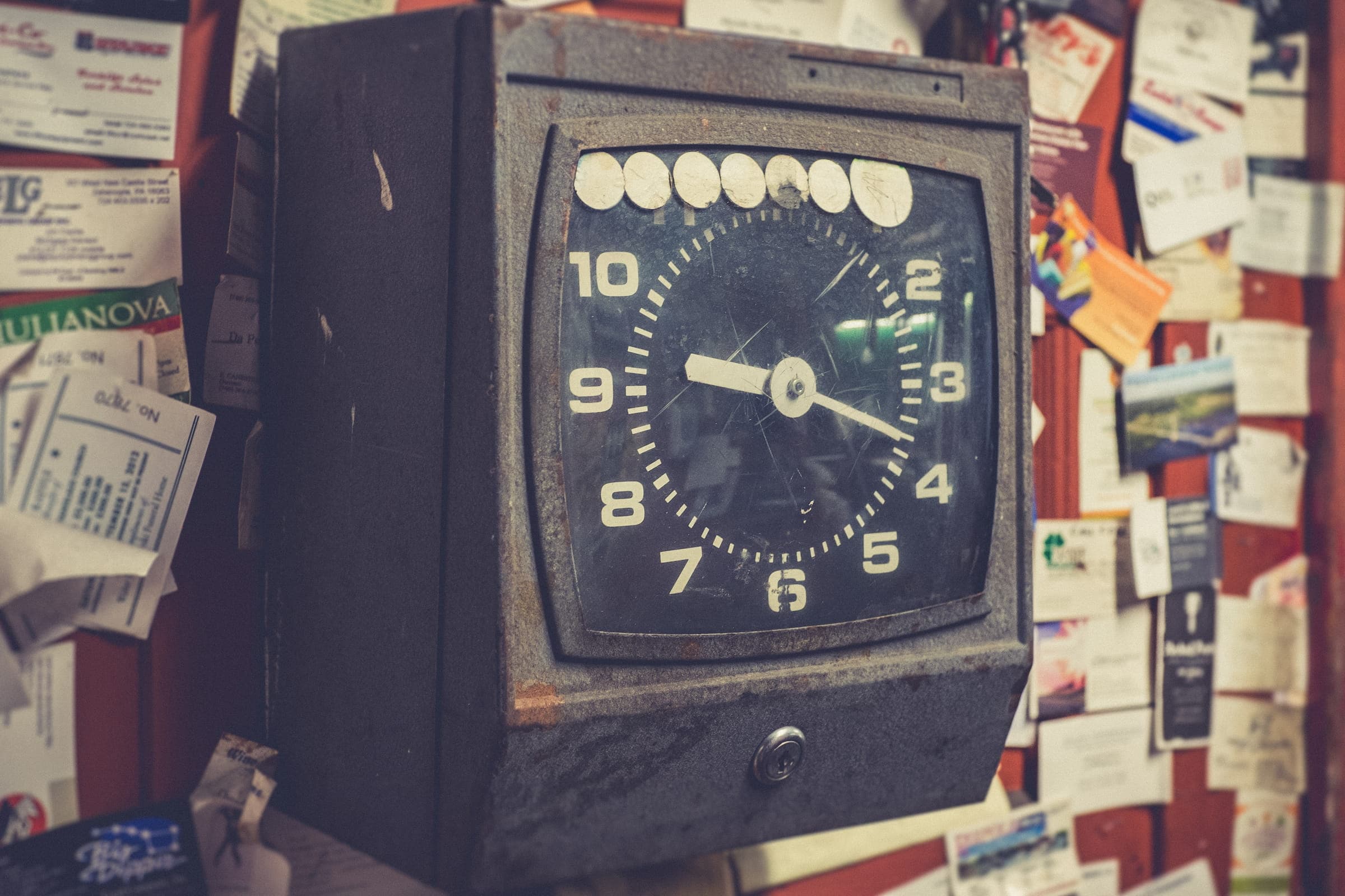 A punch clock on a desk, representing structured project requirements